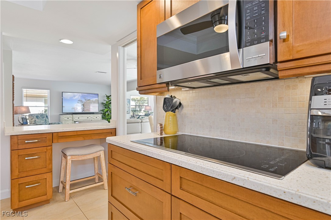 5590 Buring Court Fort Myers, FL 33919 - Photo 24 of 38 a kitchen with stainless steel appliances granite countertop a sink and a microwave