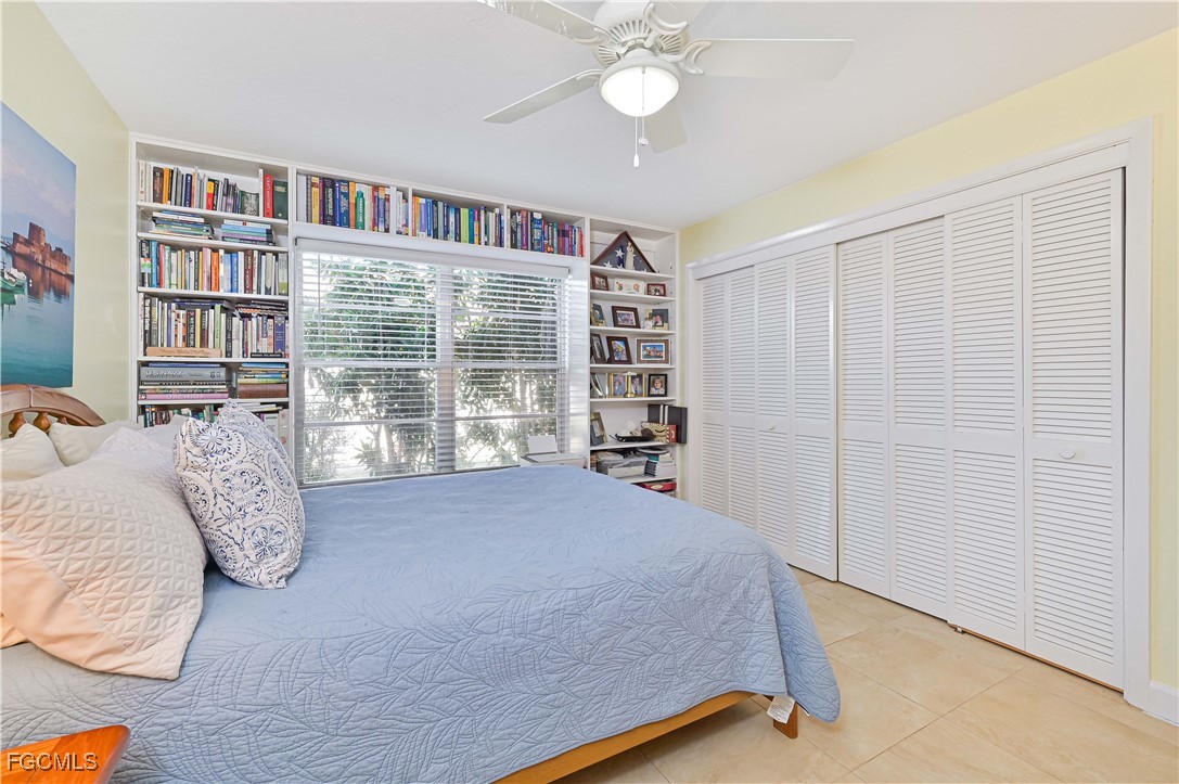 5590 Buring Court Fort Myers, FL 33919 - Photo 26 of 38 a bed sitting in a bedroom next to a book shelf
