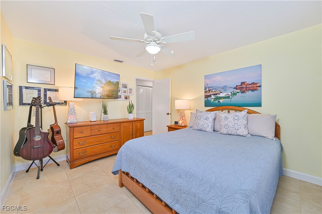 5590 Buring Court Fort Myers, FL 33919 - Photo 27 of 38 a bedroom with a bed and dresser