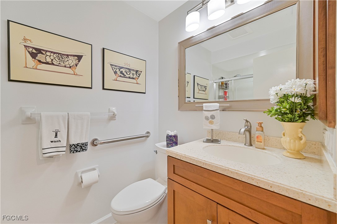 5590 Buring Court Fort Myers, FL 33919 - Photo 28 of 38 a bathroom with a sink mirror vanity and toilet