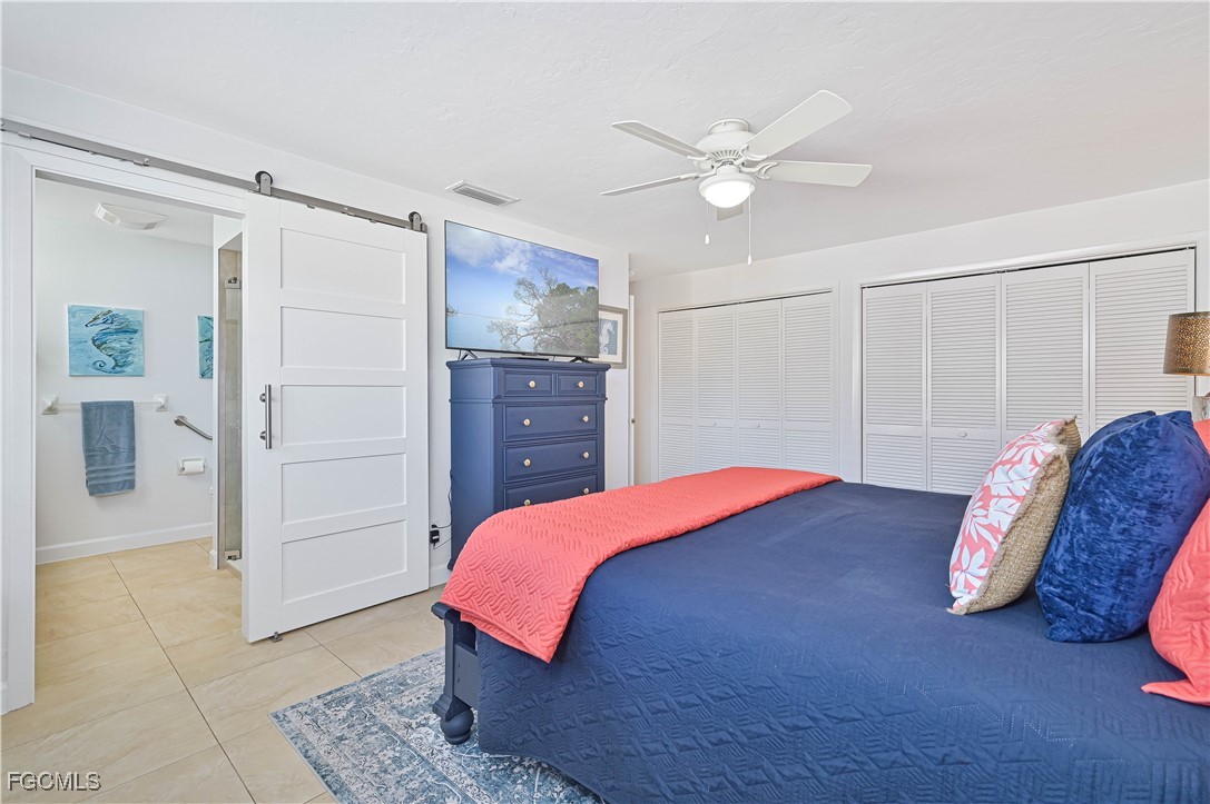 5590 Buring Court Fort Myers, FL 33919 - Photo 32 of 38 a bedroom with a bed and a chandelier