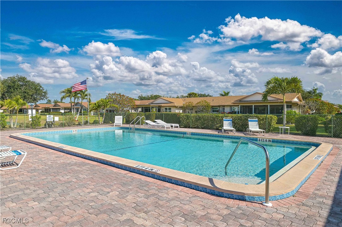 5590 Buring Court Fort Myers, FL 33919 - Photo 36 of 38 a view of a swimming pool with a bench in front of it