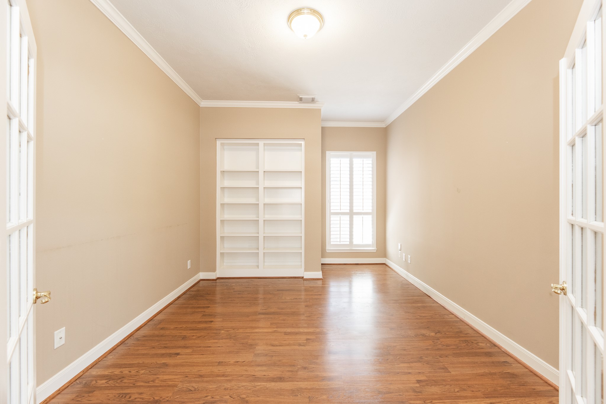 1222 Brinson Court Spring, TX 77379 - Photo 10 of 35 an empty room with wooden floor and windows