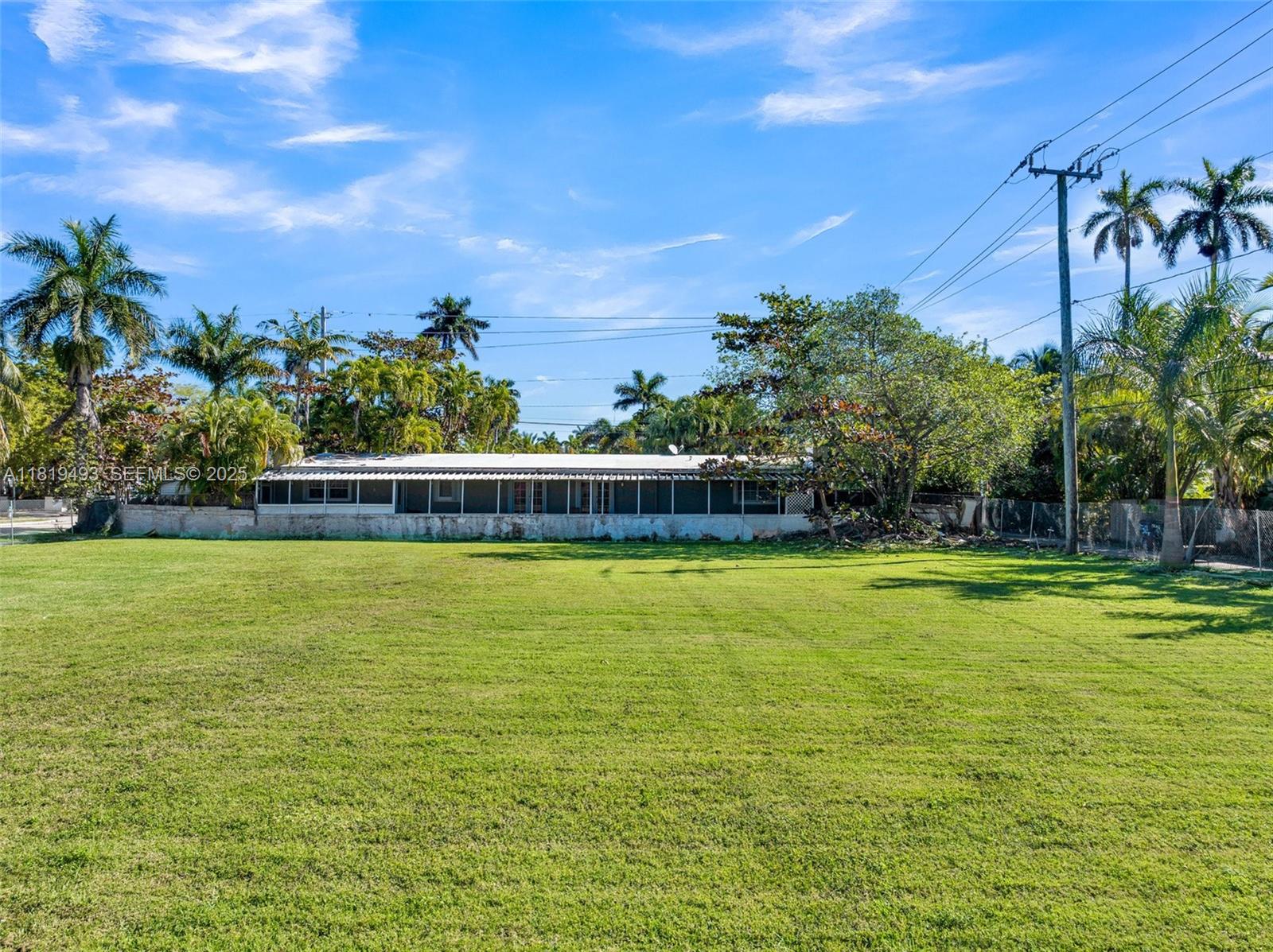1310 Polk Street Hollywood, FL 33019 - Photo 11 of 31 a view of a swimming pool with a yard