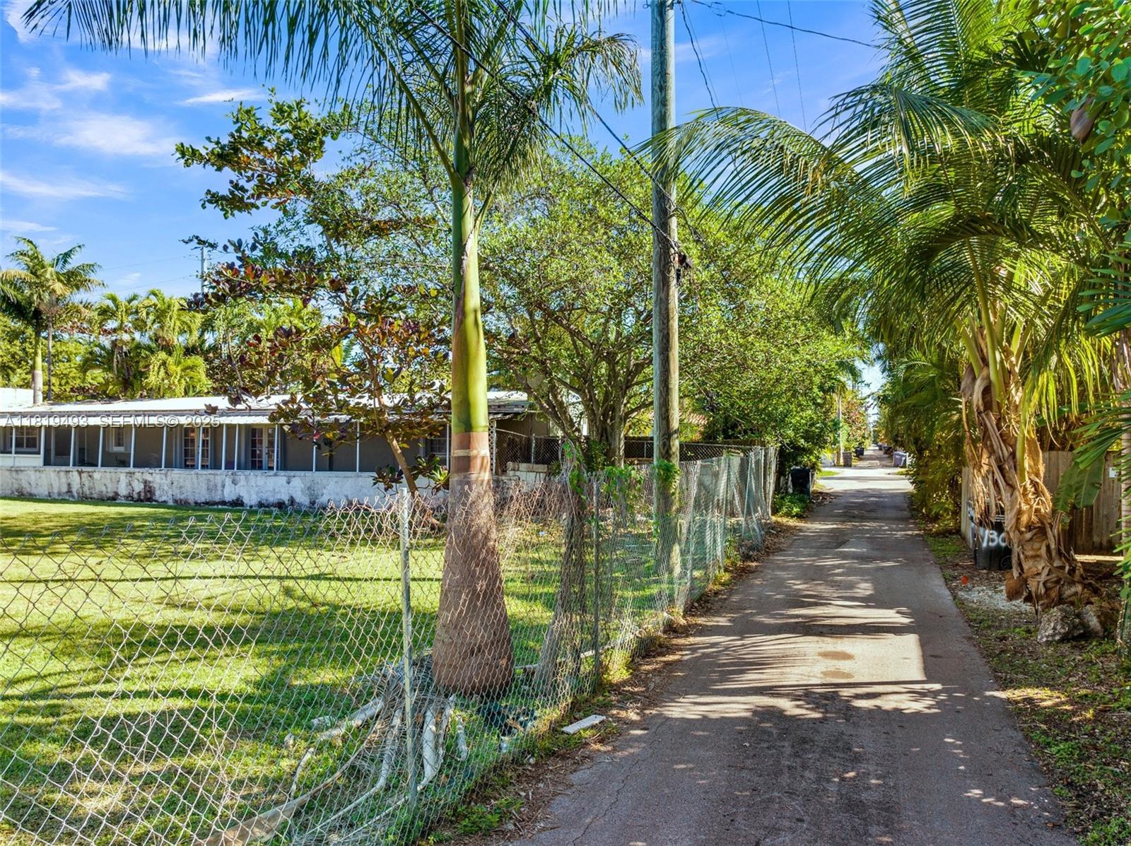 1310 Polk Street Hollywood, FL 33019 - Photo 8 of 31 a view of a yard with plants and large trees
