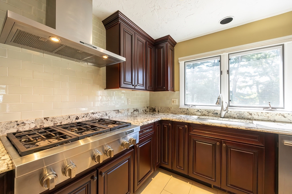 290 Central Avenue Milton, MA 02186 - Photo 16 of 40 a kitchen with a sink stove top oven and cabinets