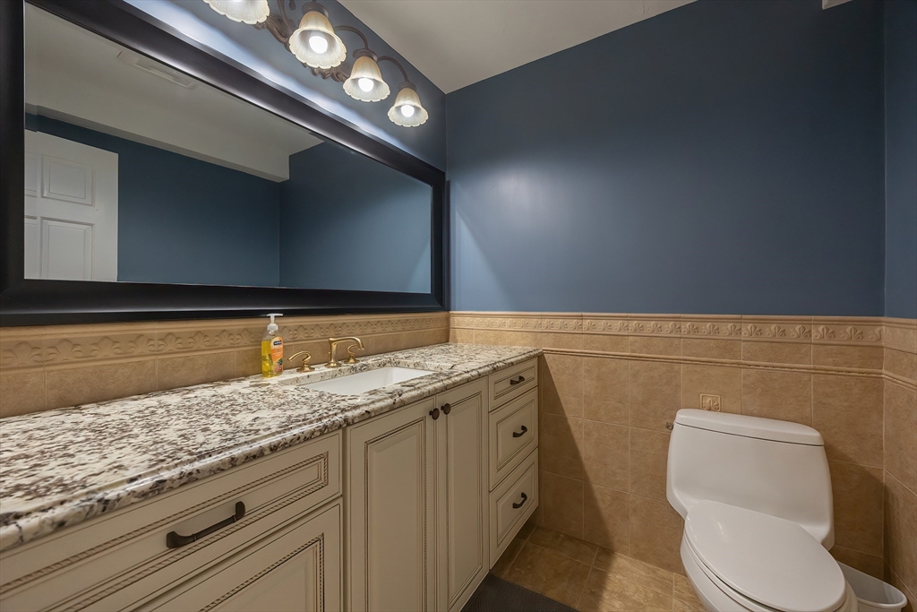 290 Central Avenue Milton, MA 02186 - Photo 17 of 40 a bathroom with a toilet sink and mirror
