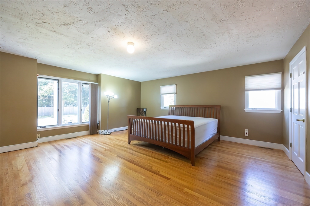 290 Central Avenue Milton, MA 02186 - Photo 19 of 40 a spacious bedroom with a bed and a window