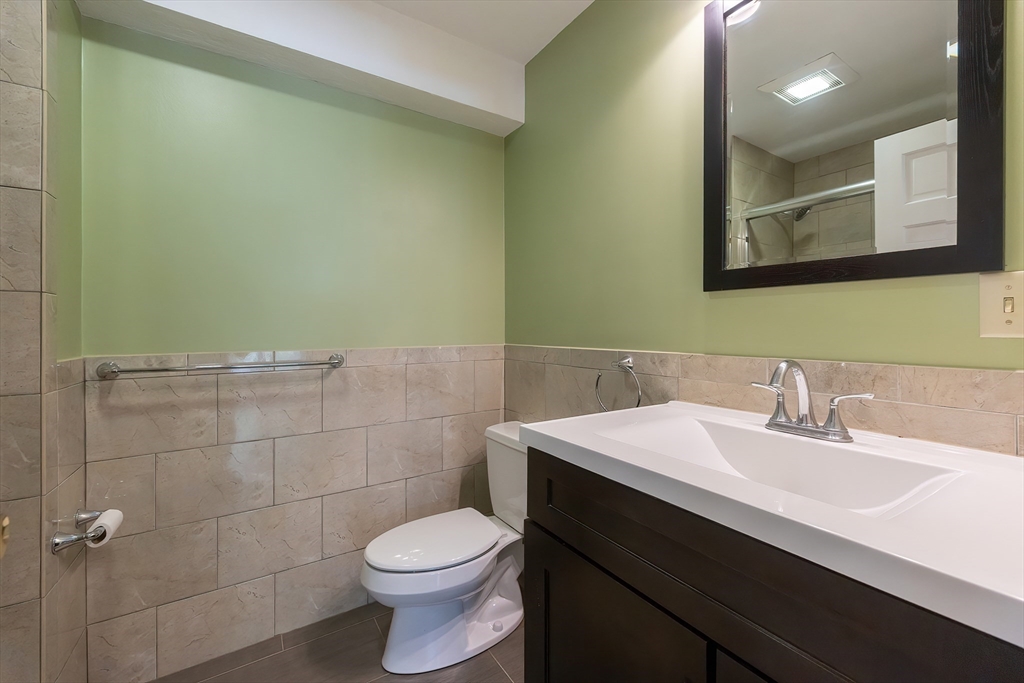290 Central Avenue Milton, MA 02186 - Photo 21 of 40 a bathroom with a sink a toilet and mirror