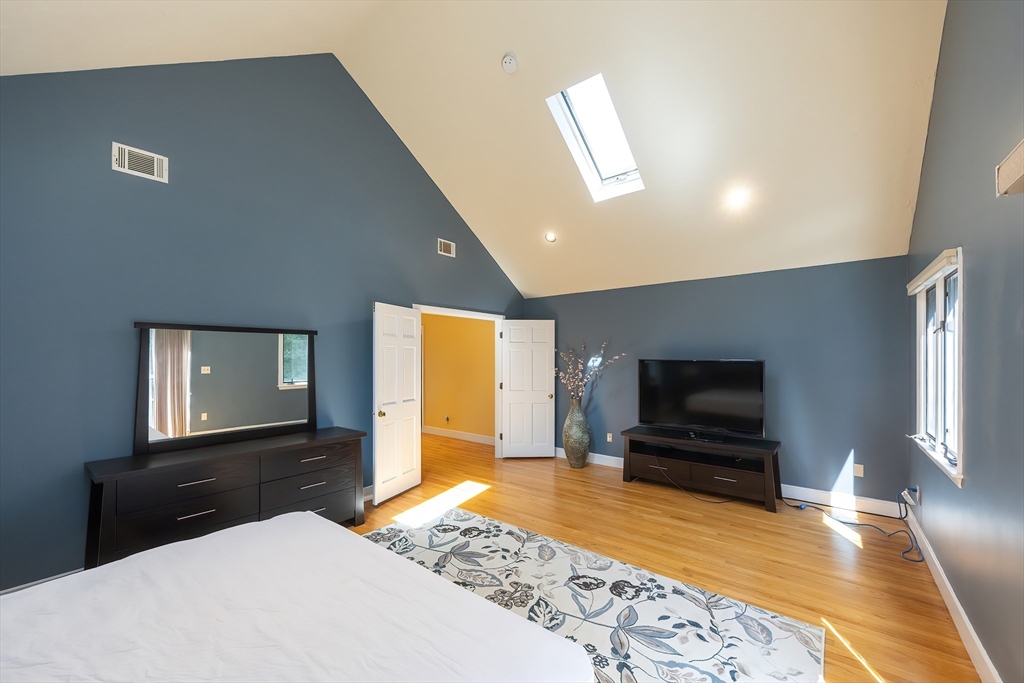 290 Central Avenue Milton, MA 02186 - Photo 24 of 40 a living room with a flat screen tv and a fireplace