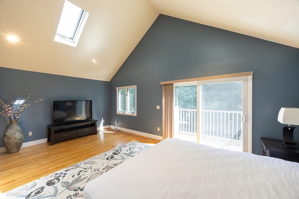 290 Central Avenue Milton, MA 02186 - Photo 25 of 40 a bedroom with a bed and wooden floor