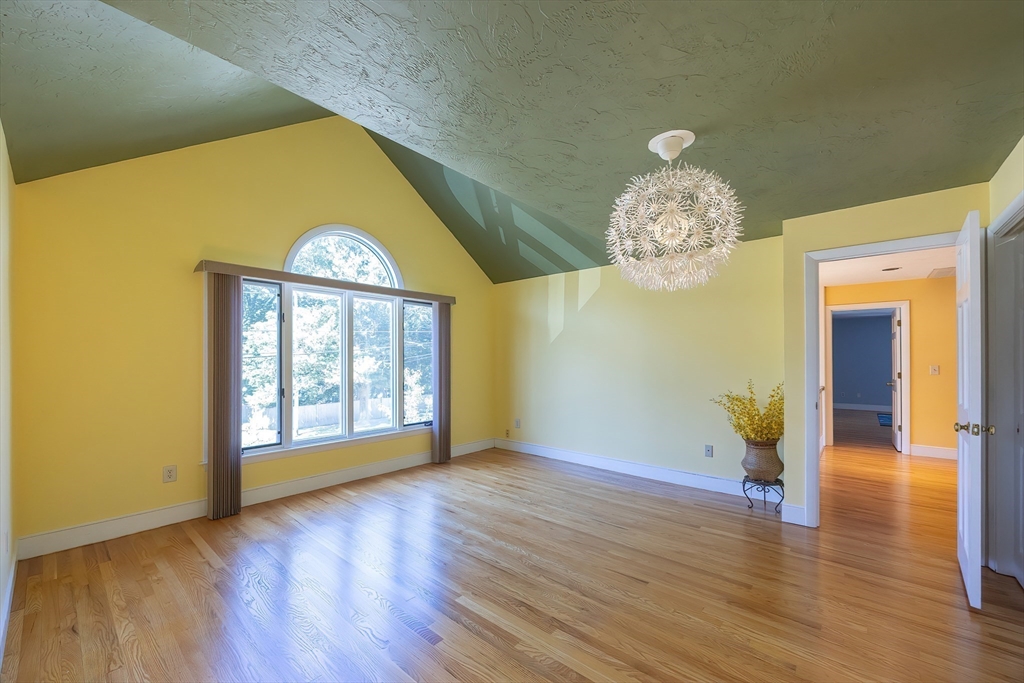 290 Central Avenue Milton, MA 02186 - Photo 31 of 40 a view of an empty room with wooden floor and a window