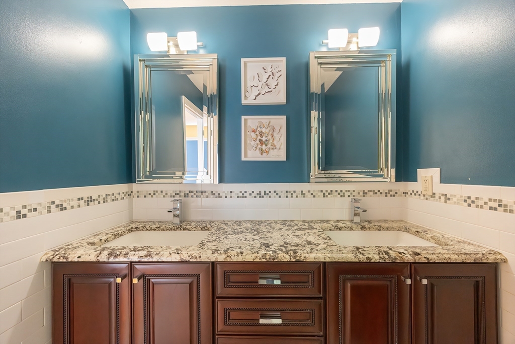 290 Central Avenue Milton, MA 02186 - Photo 32 of 40 a bathroom with a granite countertop sink and a mirror