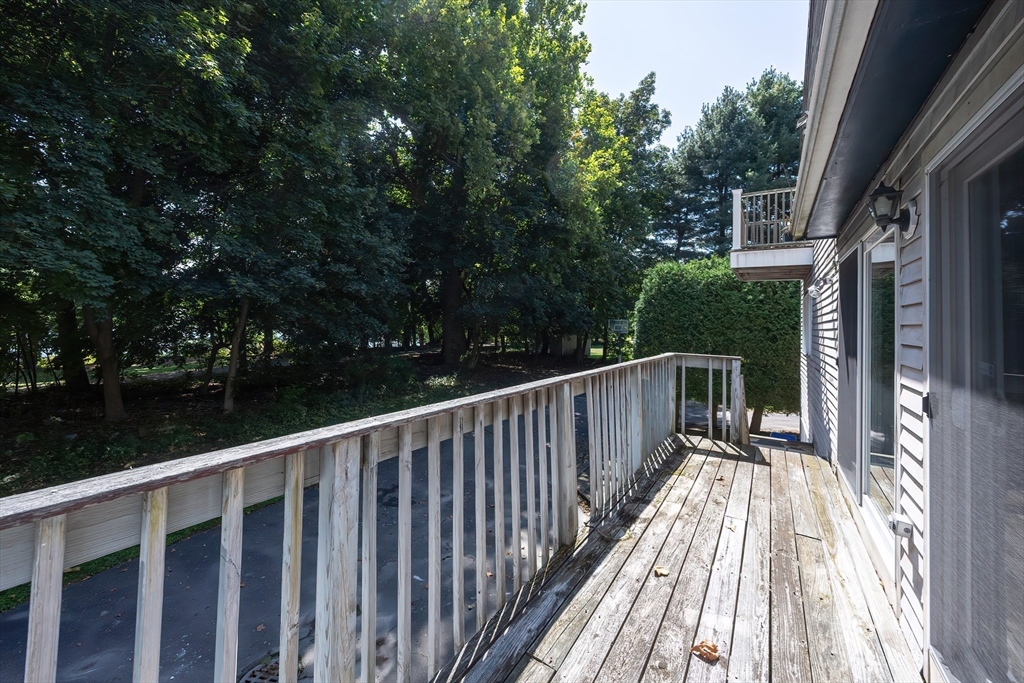 290 Central Avenue Milton, MA 02186 - Photo 34 of 40 a balcony with wooden floor and fence