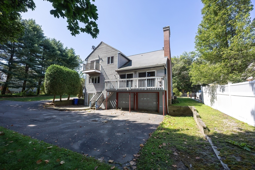 290 Central Avenue Milton, MA 02186 - Photo 35 of 40 a front view of a house with a yard and garage