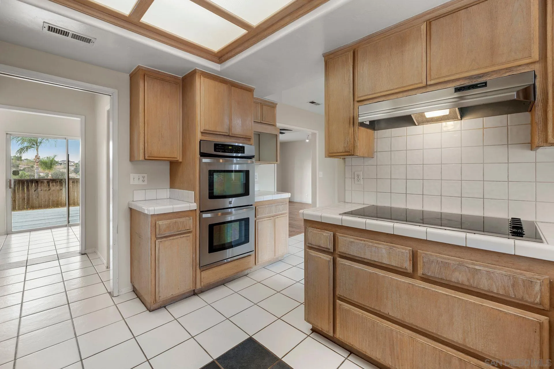 960 Sunset Drive Vista, CA 92081 - Photo 19 of 39 a kitchen with cabinets and steel stainless steel appliances