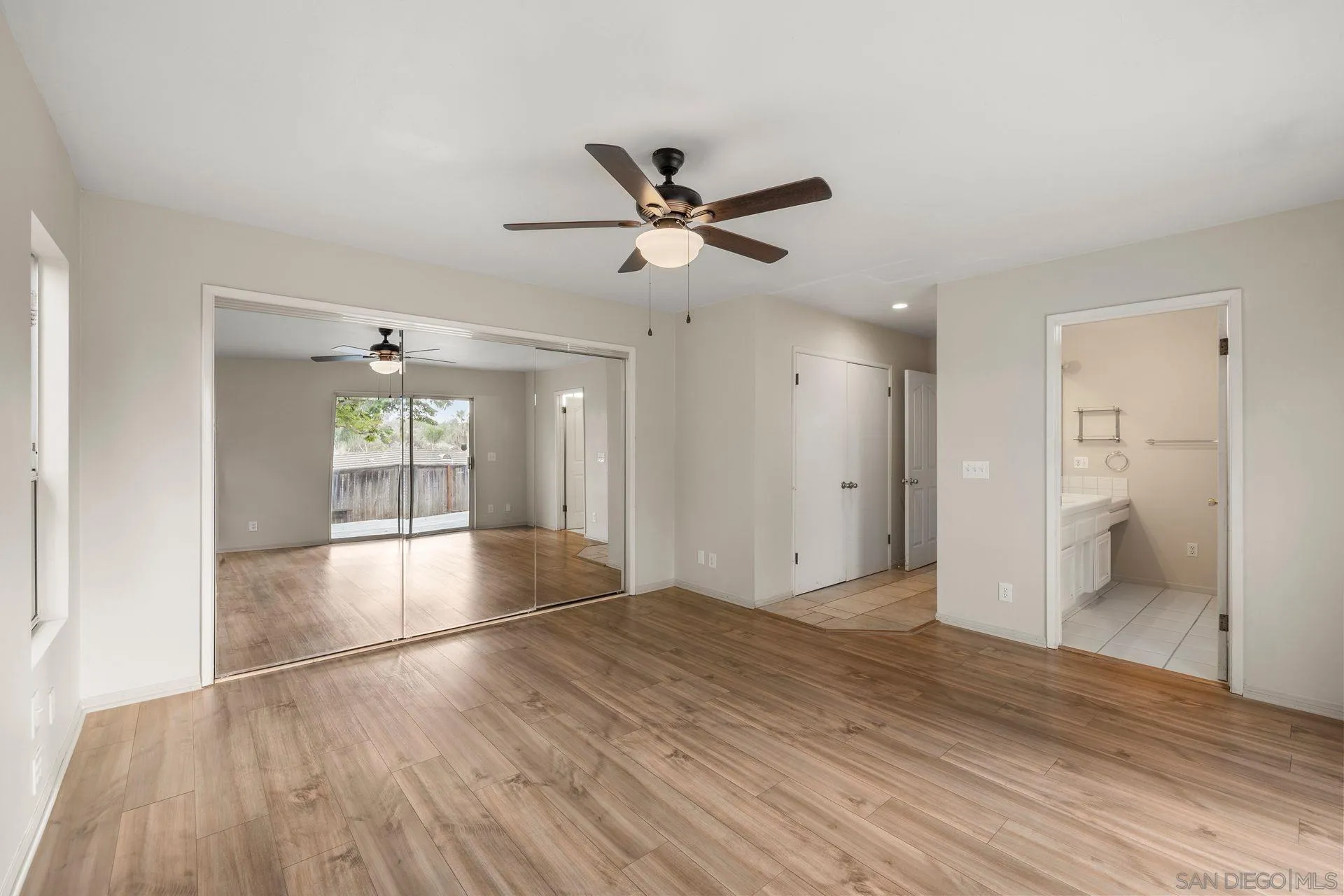 960 Sunset Drive Vista, CA 92081 - Photo 26 of 39 a view of an empty room with wooden floor and a window