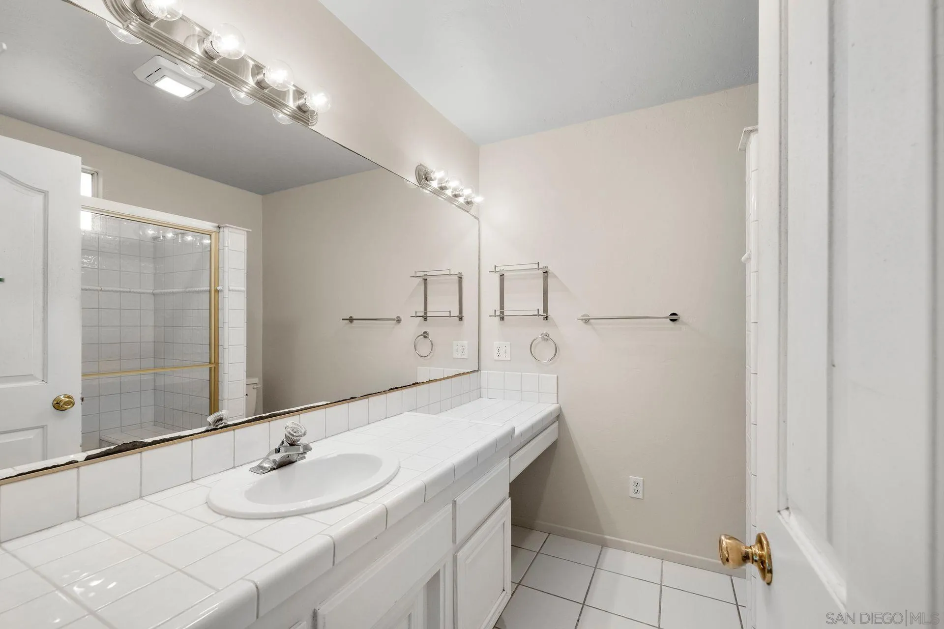 960 Sunset Drive Vista, CA 92081 - Photo 27 of 39 a bathroom with a sink double vanity and a mirror