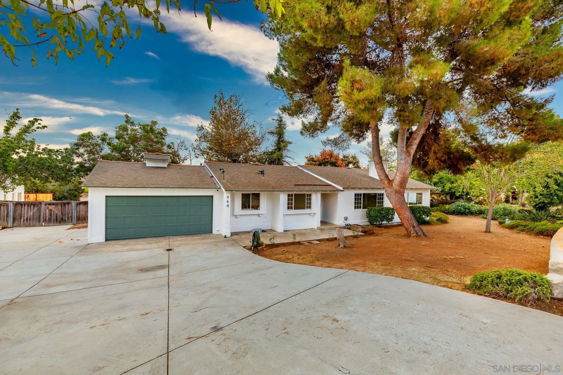 960 Sunset Drive Vista, CA 92081 - Photo 5 of 39 a front view of a house with a yard and garage