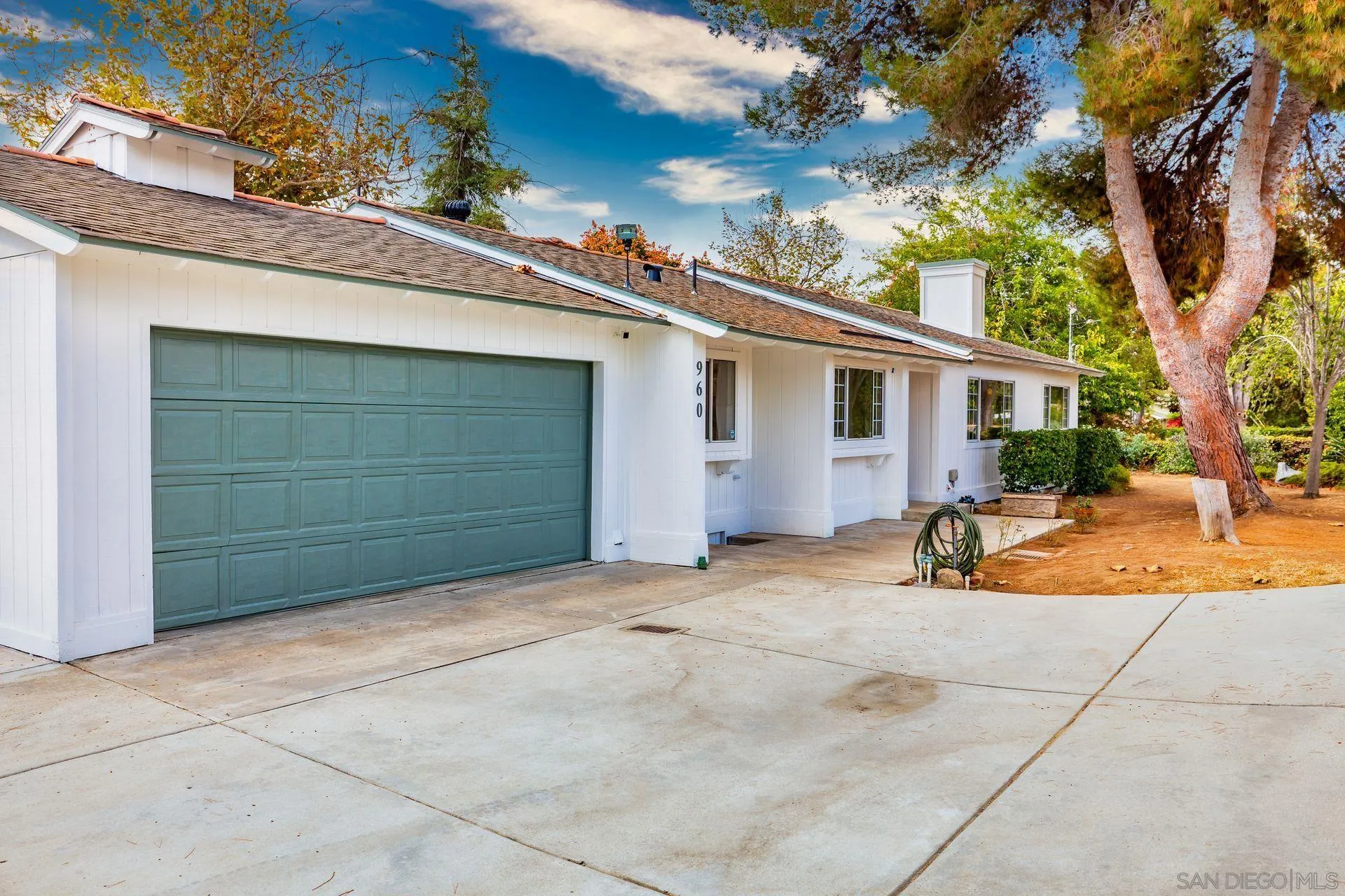 960 Sunset Drive Vista, CA 92081 - Photo 6 of 39 a view of a house with a backyard and a garage