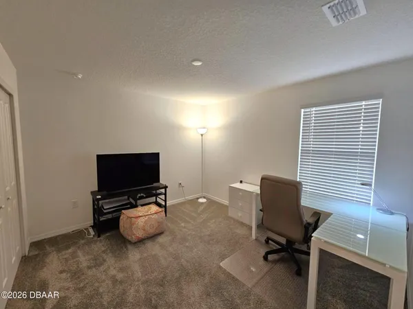 a bedroom with a bed and a night stand