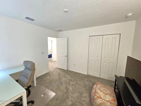 a bedroom with a bed and a lamp