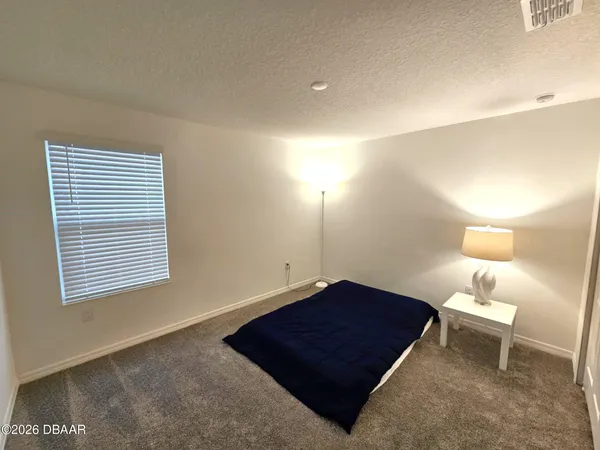 a bedroom with bed and chair