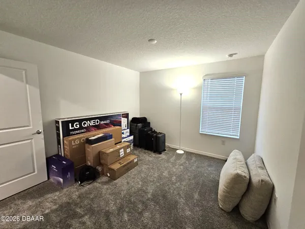 a living room with a couch and a night stand with wooden floor