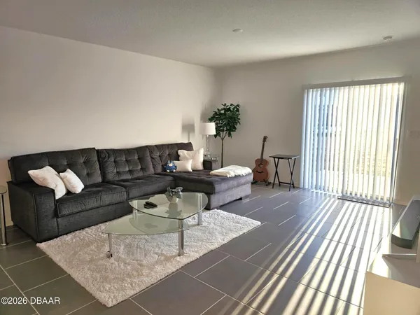 a view of a livingroom with furniture and front door