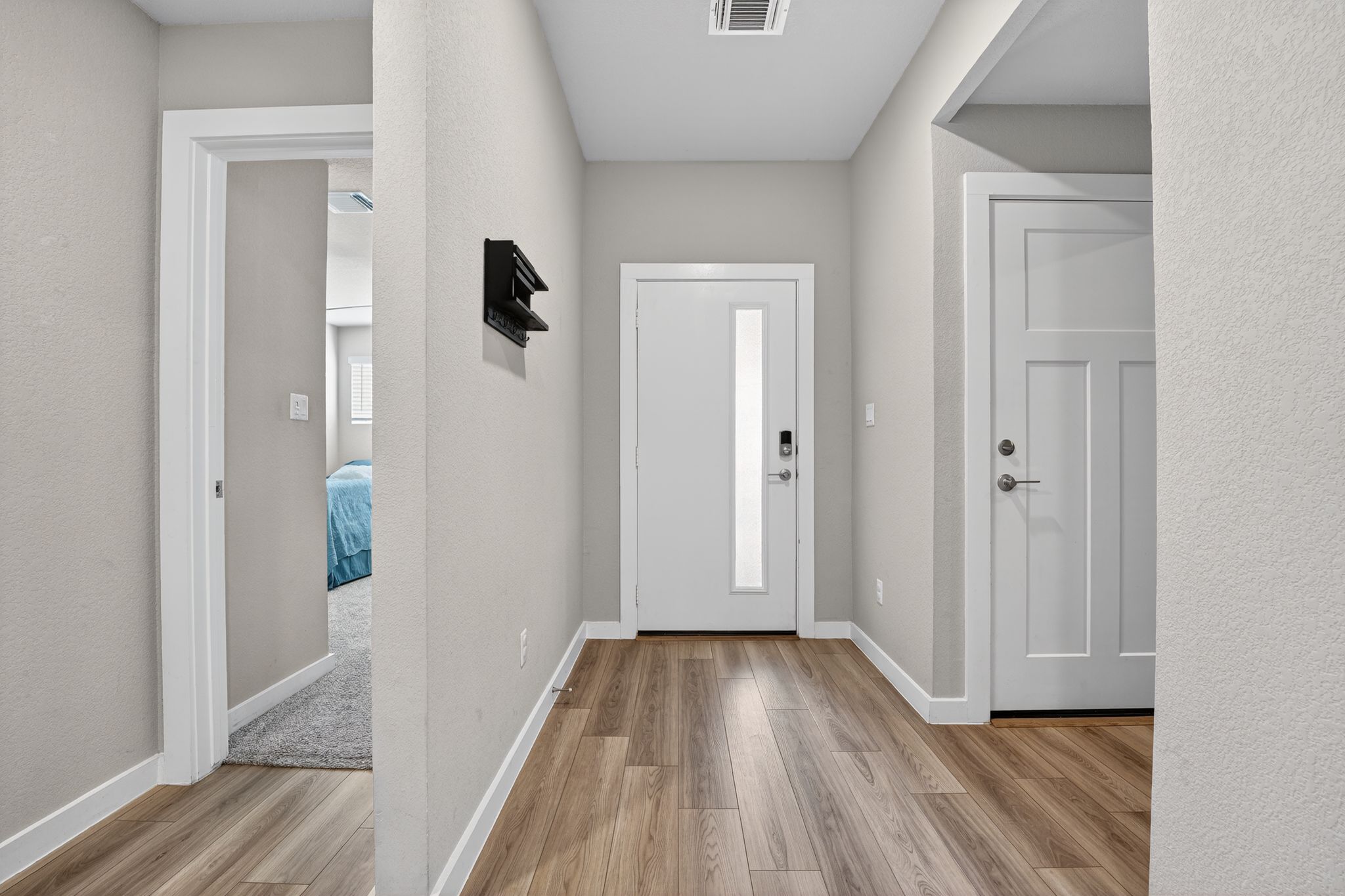 117 Halford Road Georgetown, TX 78633 - Photo 3 of 31 Foyer with light wood-style floors and a textured wall