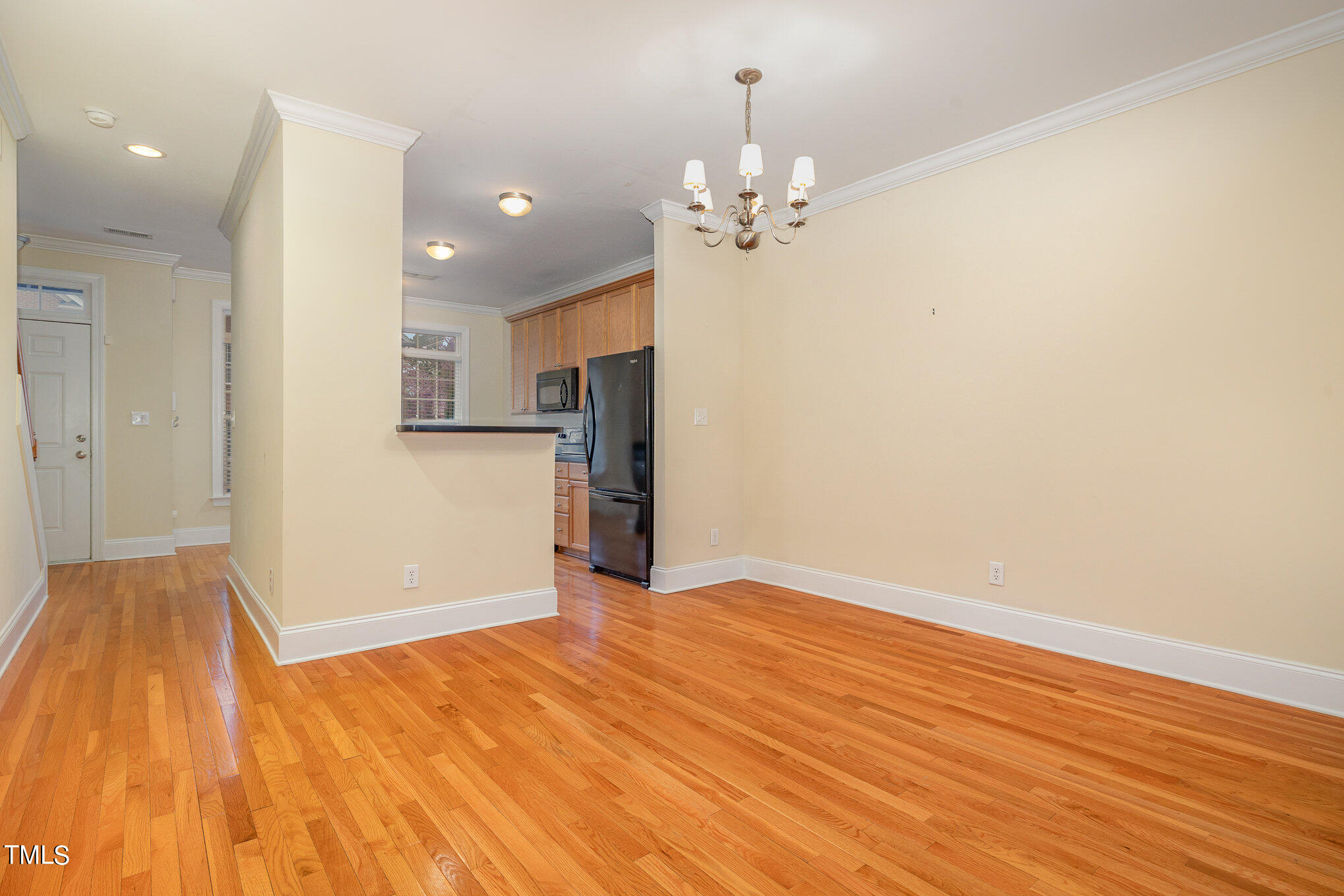 673 Highpark Lane Raleigh, NC 27608 - Photo 11 of 22 a view of empty room with wooden floor and kitchen