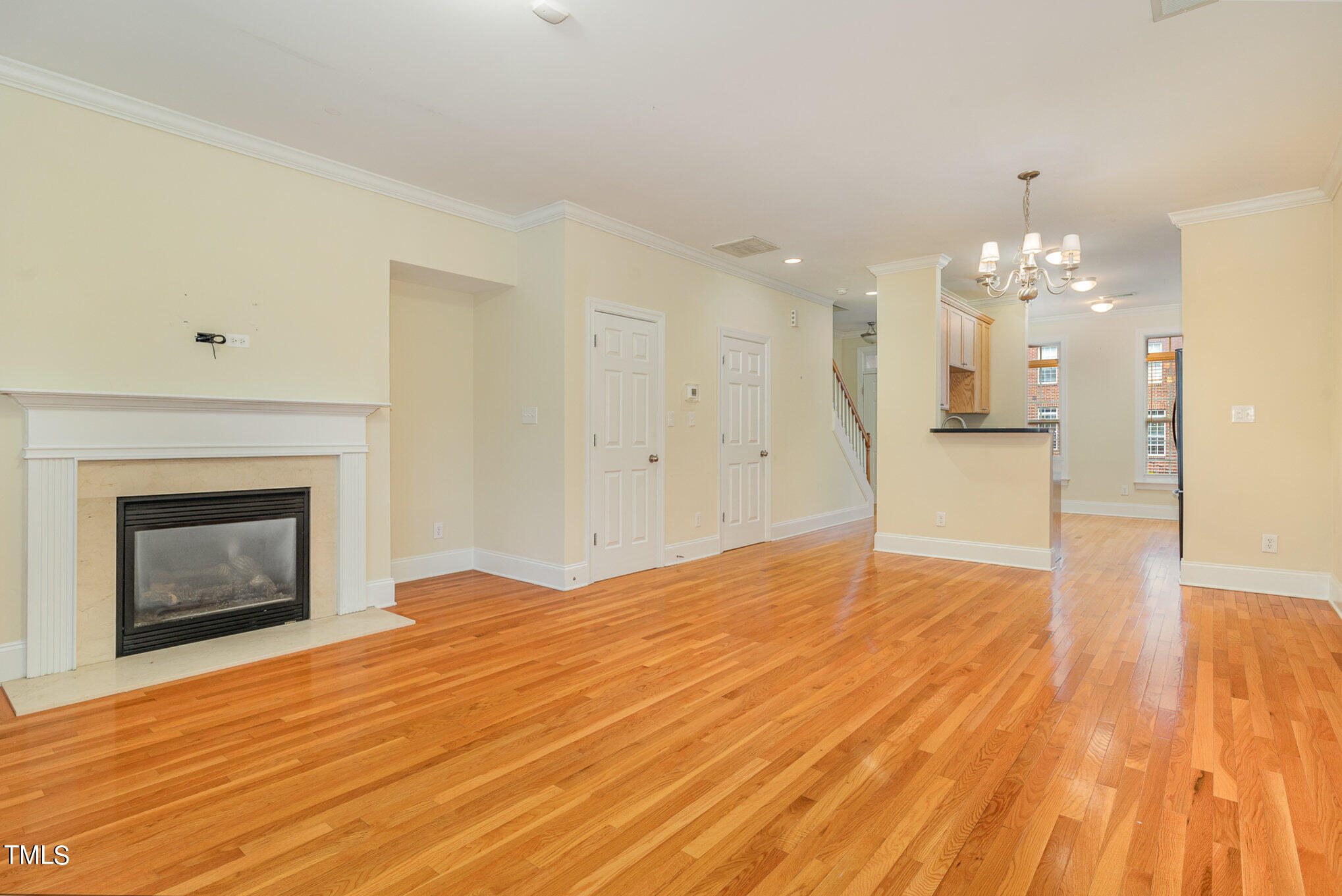 673 Highpark Lane Raleigh, NC 27608 - Photo 13 of 22 a view of empty room with wooden floor and fireplace
