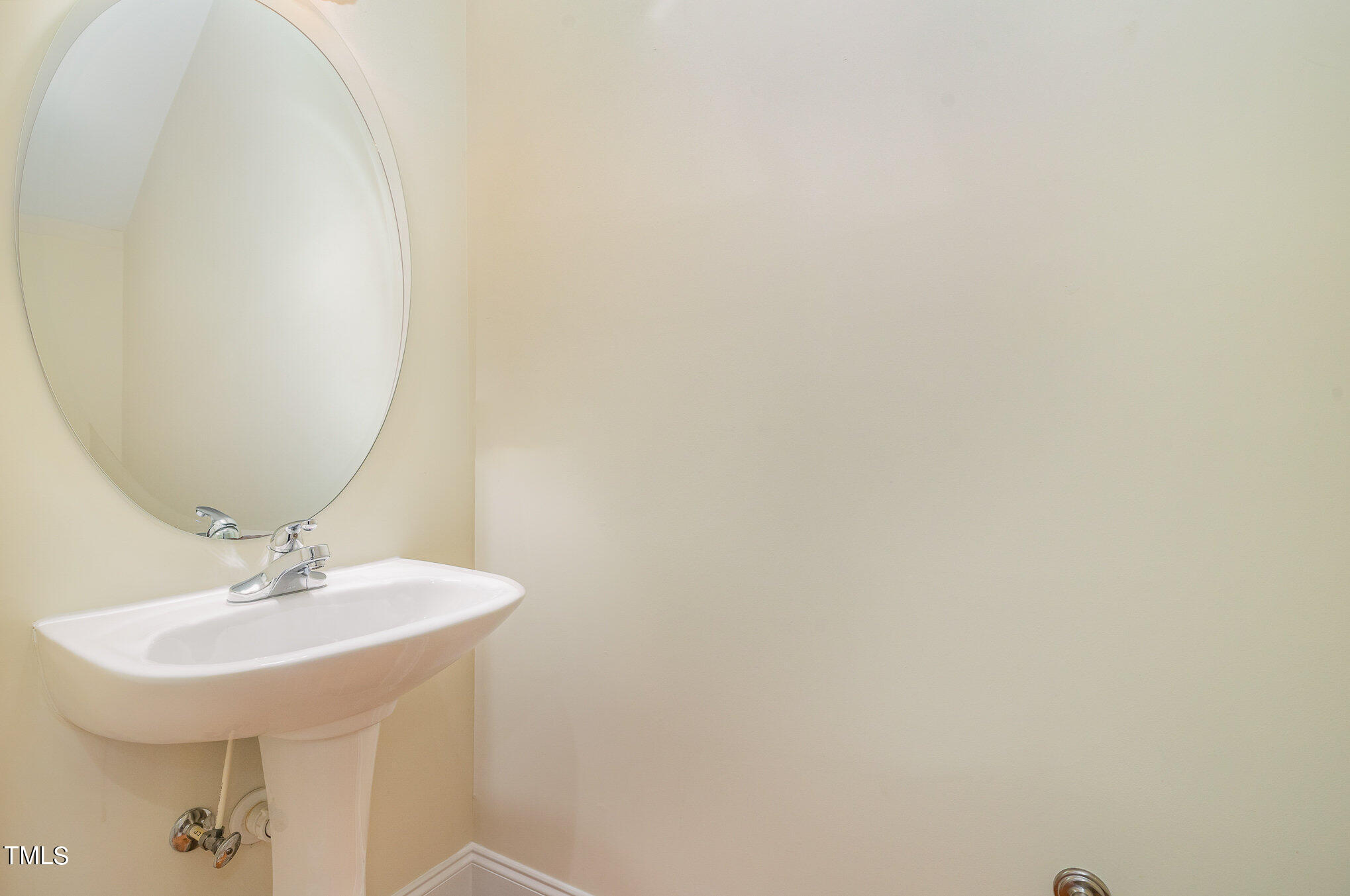 673 Highpark Lane Raleigh, NC 27608 - Photo 14 of 22 a bathroom with a sink and a mirror