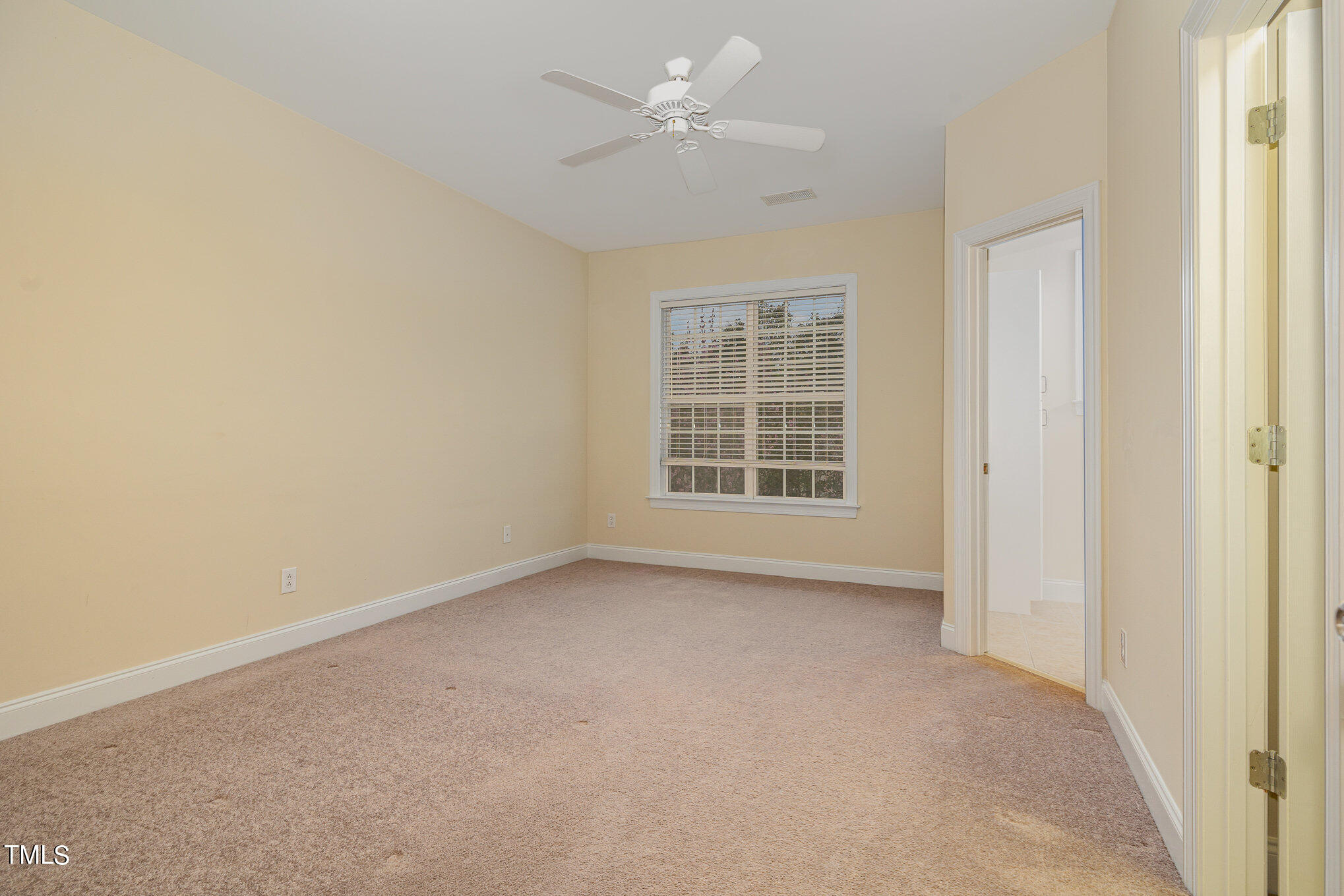 673 Highpark Lane Raleigh, NC 27608 - Photo 15 of 22 an empty room with a window and a ceiling fan
