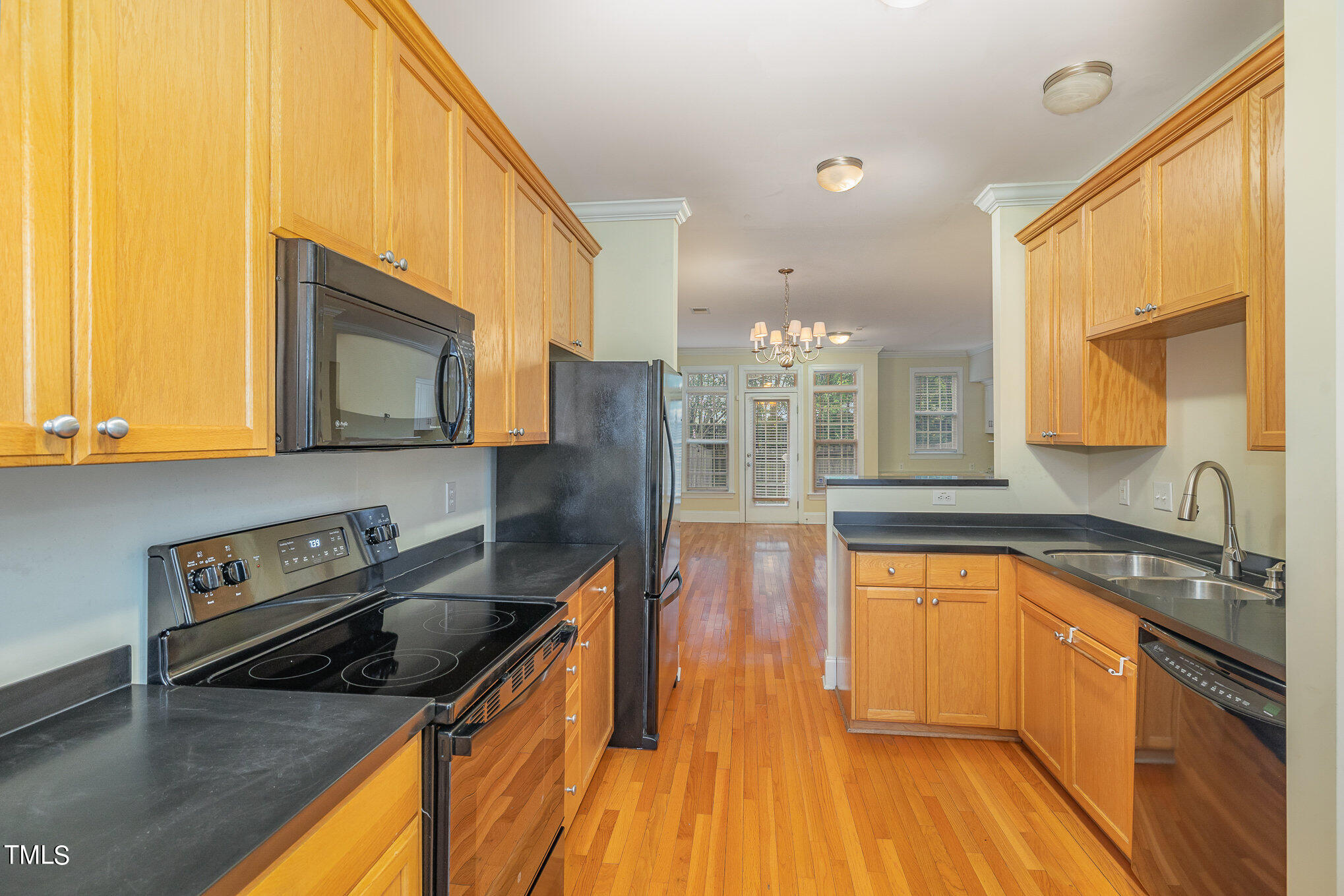 673 Highpark Lane Raleigh, NC 27608 - Photo 9 of 22 a kitchen with wooden floors and a sink