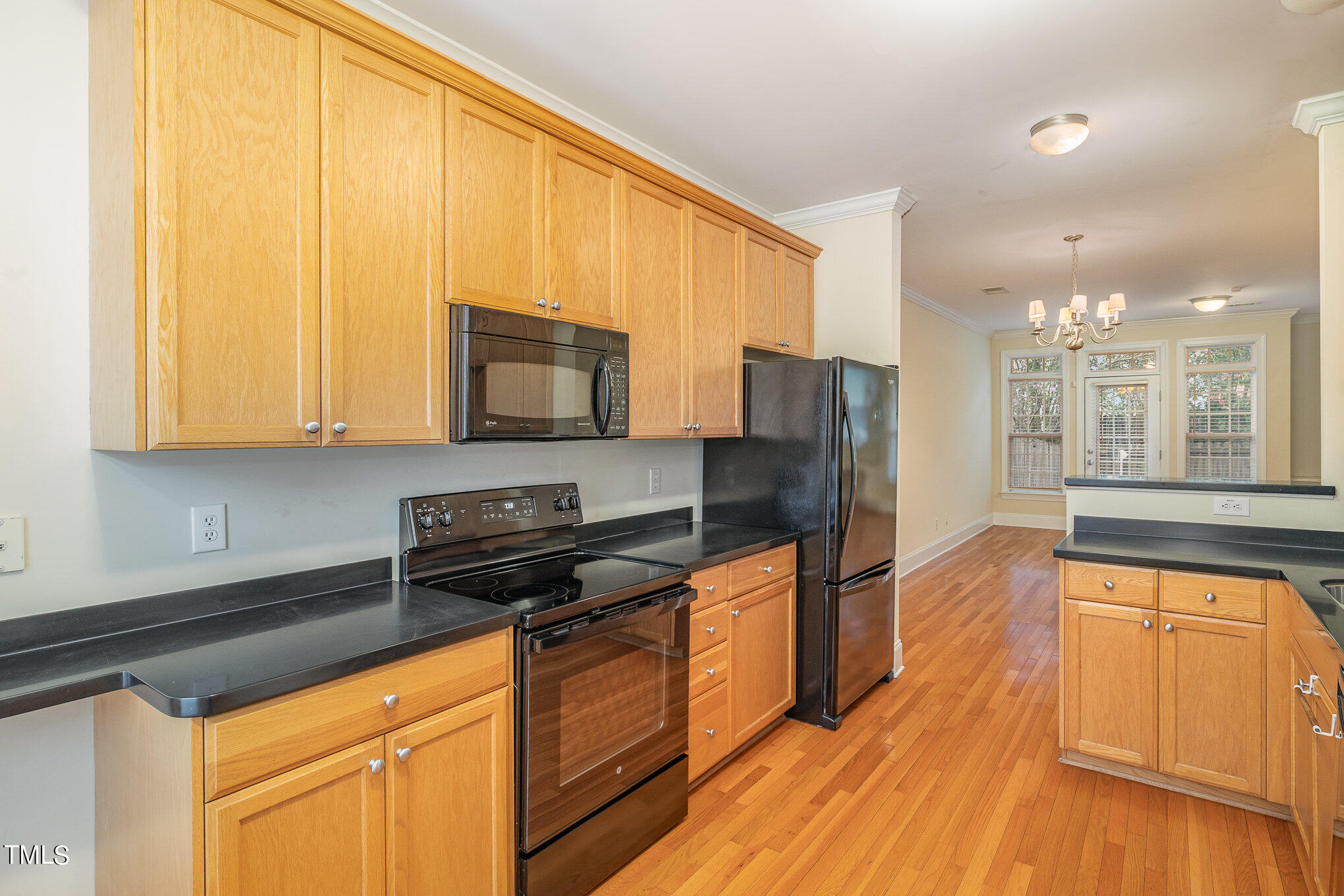673 Highpark Lane Raleigh, NC 27608 - Photo 10 of 22 a kitchen with stainless steel appliances granite countertop a stove a sink and a microwave