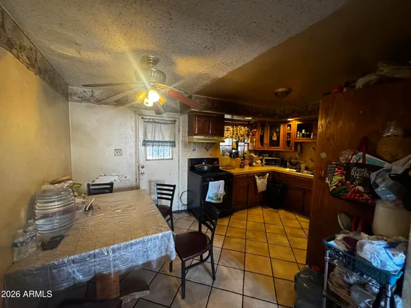 a living room with furniture a dining table and a fireplace