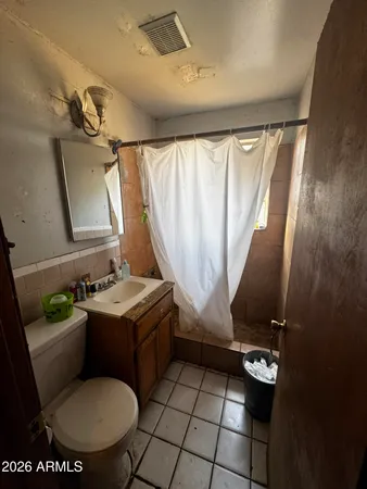 a bathroom with a sink mirror vanity and toilet