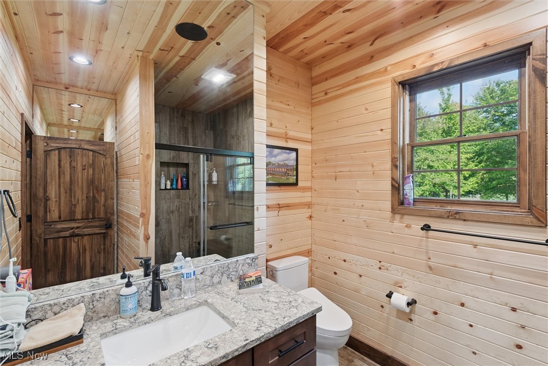 290 Townline Road Aurora, OH 44202 - Photo 25 of 50 Bathroom with wood walls, vanity, a stall shower, and wood ceiling