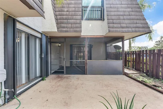 a view of backyard and wooden fence