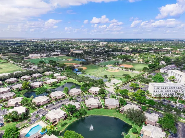 a view of a hallway with entryway wooden floor and livingroom