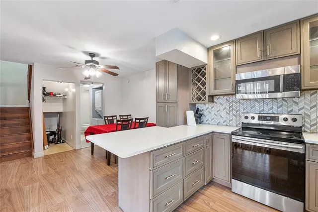 a kitchen with a stove a refrigerator and a sink