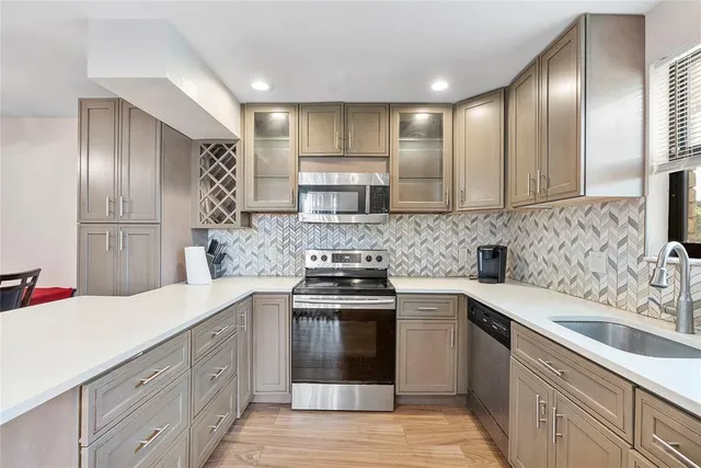 a kitchen with a sink stove and cabinets