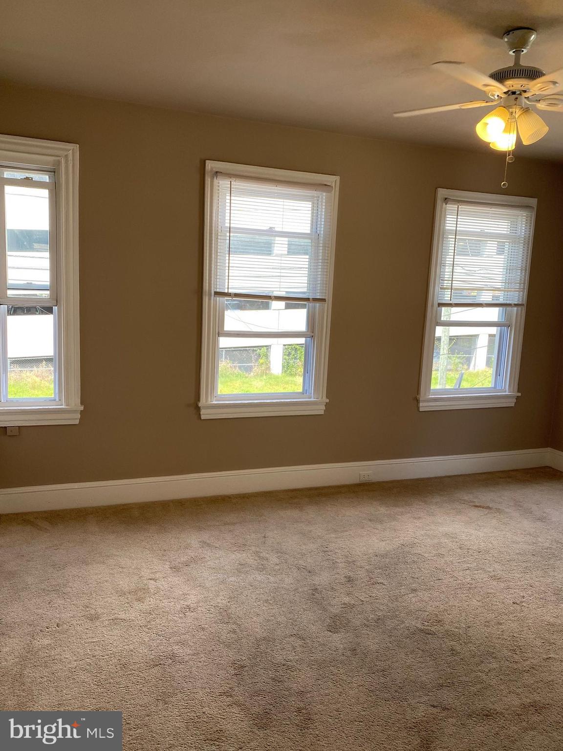 14 B Walnut Street Salem, NJ 08079 - Photo 3 of 14 an empty room with windows and fan