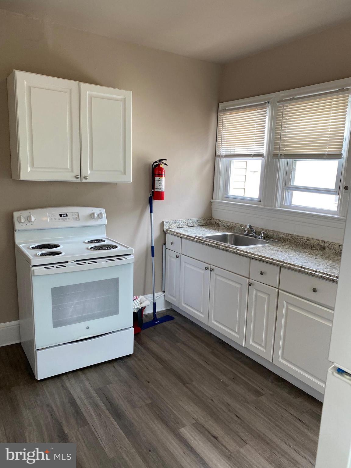 14 B Walnut Street Salem, NJ 08079 - Photo 5 of 14 a kitchen with granite countertop white cabinets and white appliances
