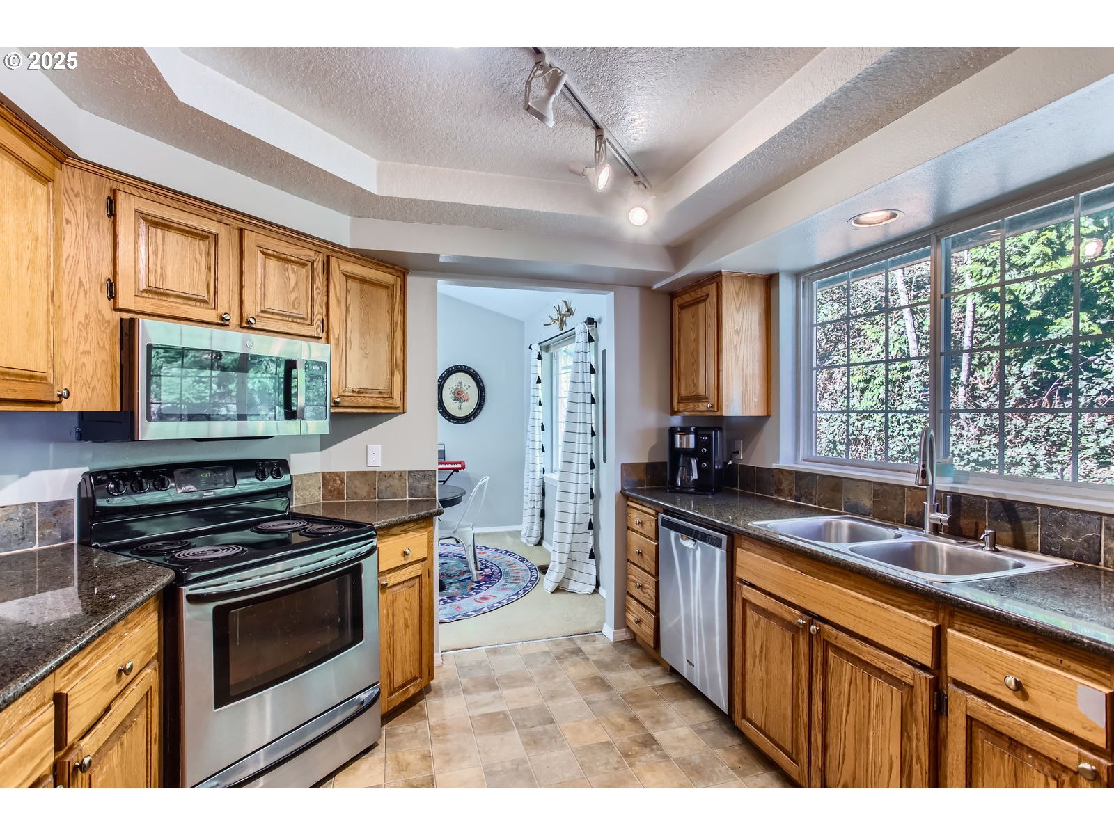 37425 Dubarko Road Sandy, OR 97055 - Photo 10 of 32 a kitchen with stainless steel appliances granite countertop a stove and a sink