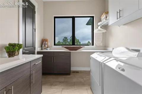 a room with a sink and a washer dryer