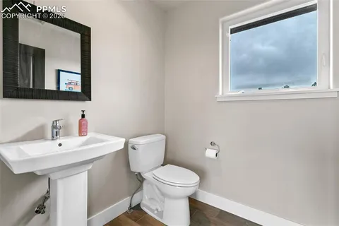 a bathroom with a toilet a sink and mirror