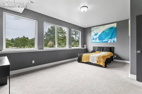 a bedroom with a large bed and a large window