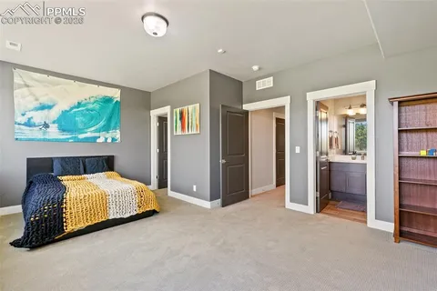 a bedroom with a bed and a large window